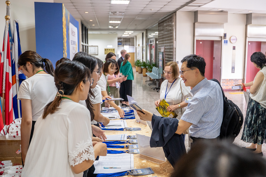 Conference attendees check in at the registration desk.